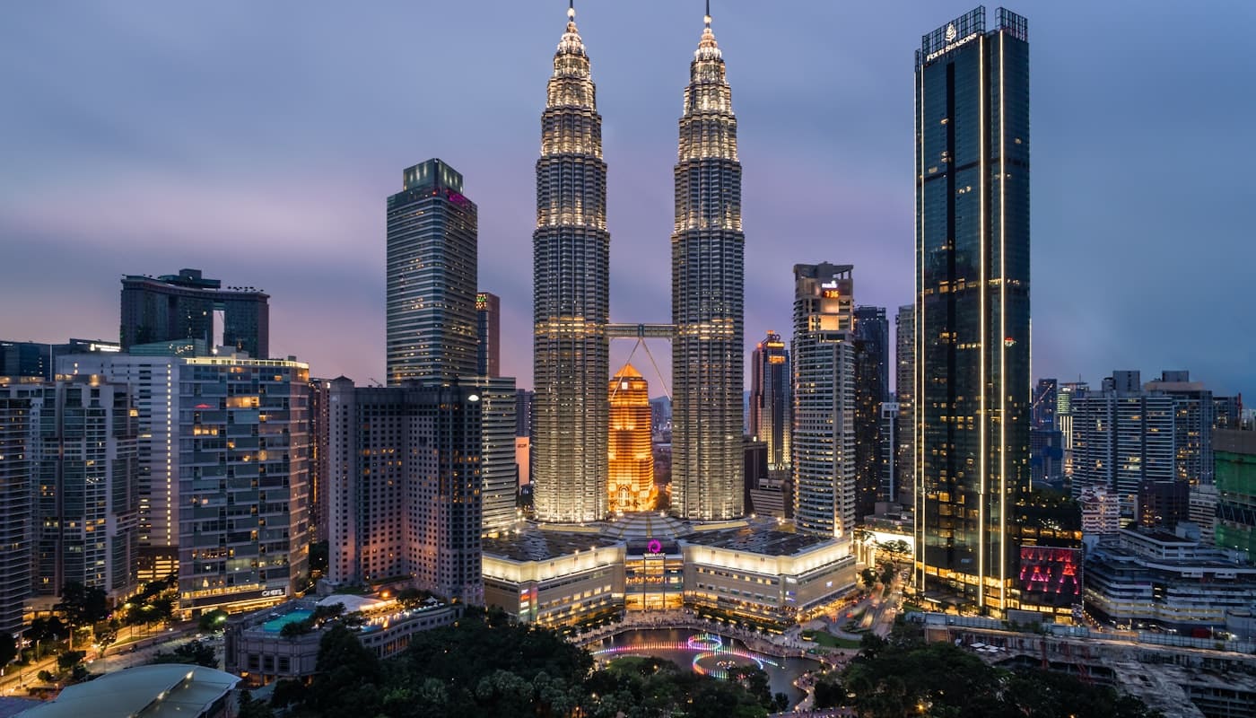 Kuala Lumpur skyline anchored by the Petronas Twin Towers at golden hour