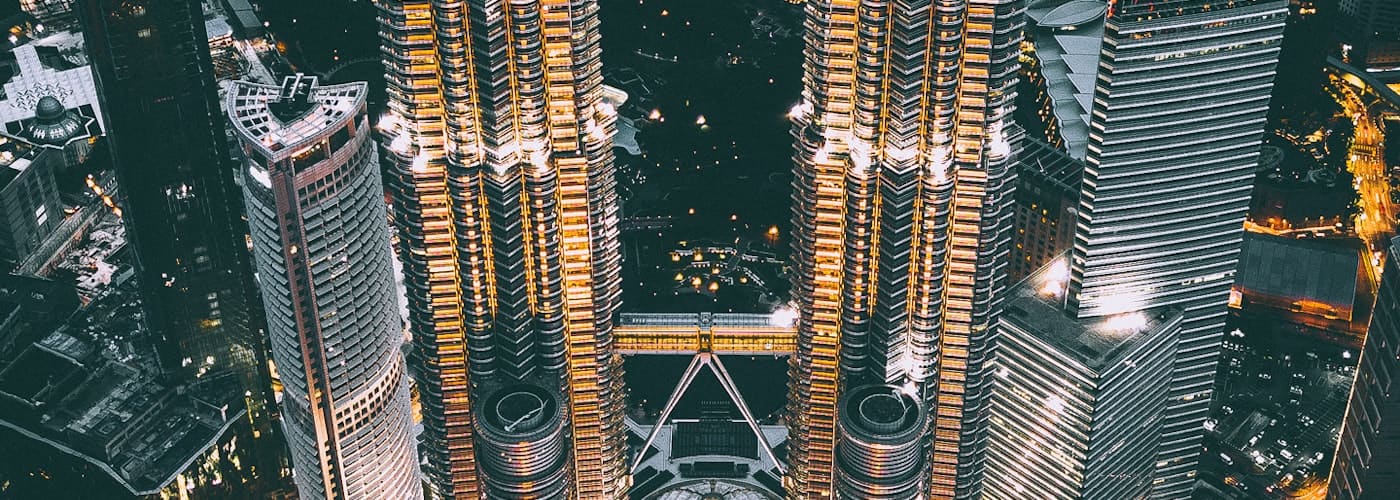 Kuala Lumpur skyline at night above Malaysian residential districts